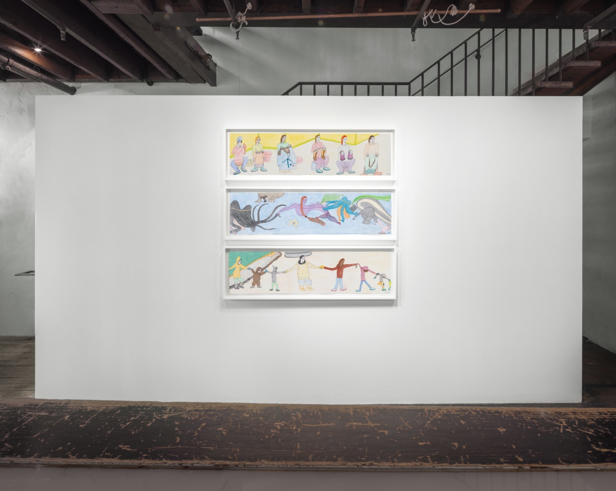 Installation view of Shuvinai Ashoona's &quot;Looking Out, Looking In&quot; exhibition with three works of art suspended one on top of the other. Done in colored pencil and ink on paper.