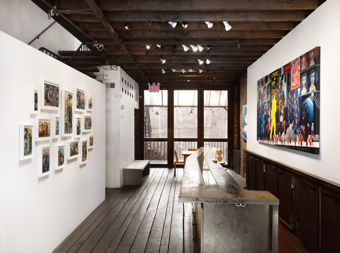 An image of the front lobby of the gallery with a large painting and mini framed prints
