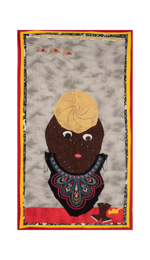 A quilt depicting a brown figure wearing an embroidered top