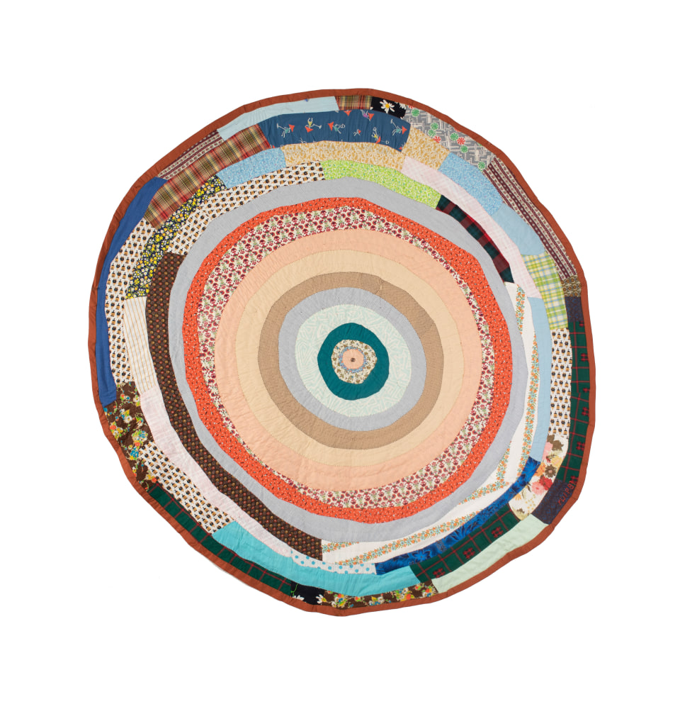 A colorful circular assorted fabric quilt