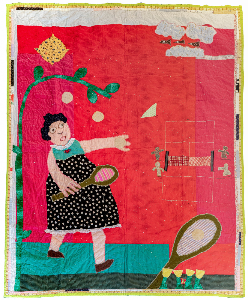 A quilt of a woman with a tennis racket throwing a ball