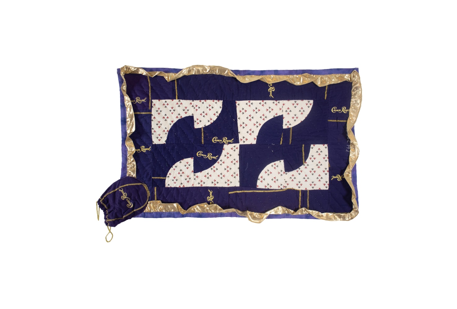 Dark blue and cream assorted fabric quilt with a gold trim