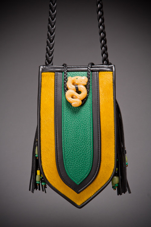 Shield Evening Purse
Hair-on calfskin, pebble green cowhide, cowhide binding and braided strap, yellow quartz hand-carved dragon enclosure, semi-precious beaded tassel and back.
5&amp;quot; x 9&amp;quot; x 3&amp;quot;
2019