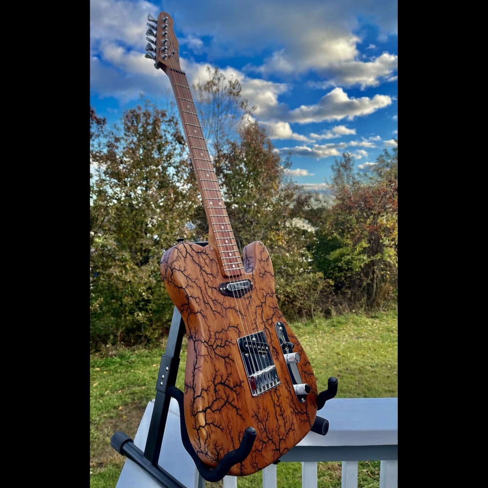 Electrocuted Cherry Guitar with a Tigerwood over Cherry Neck

13&amp;quot; x 38&amp;quot; x 3&amp;quot;