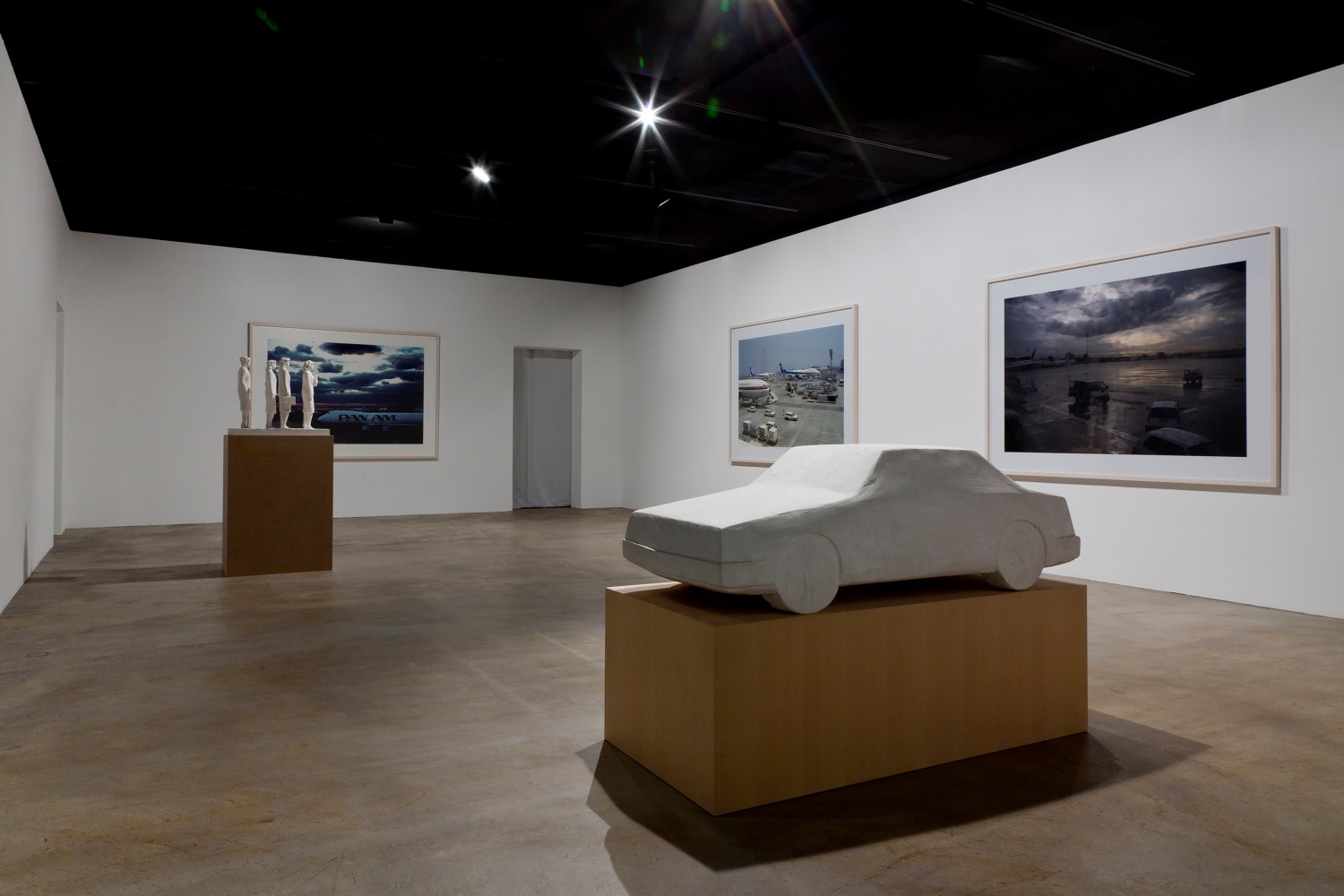Installation view of sculptures and photographs by Peter Fischli and David Weiss