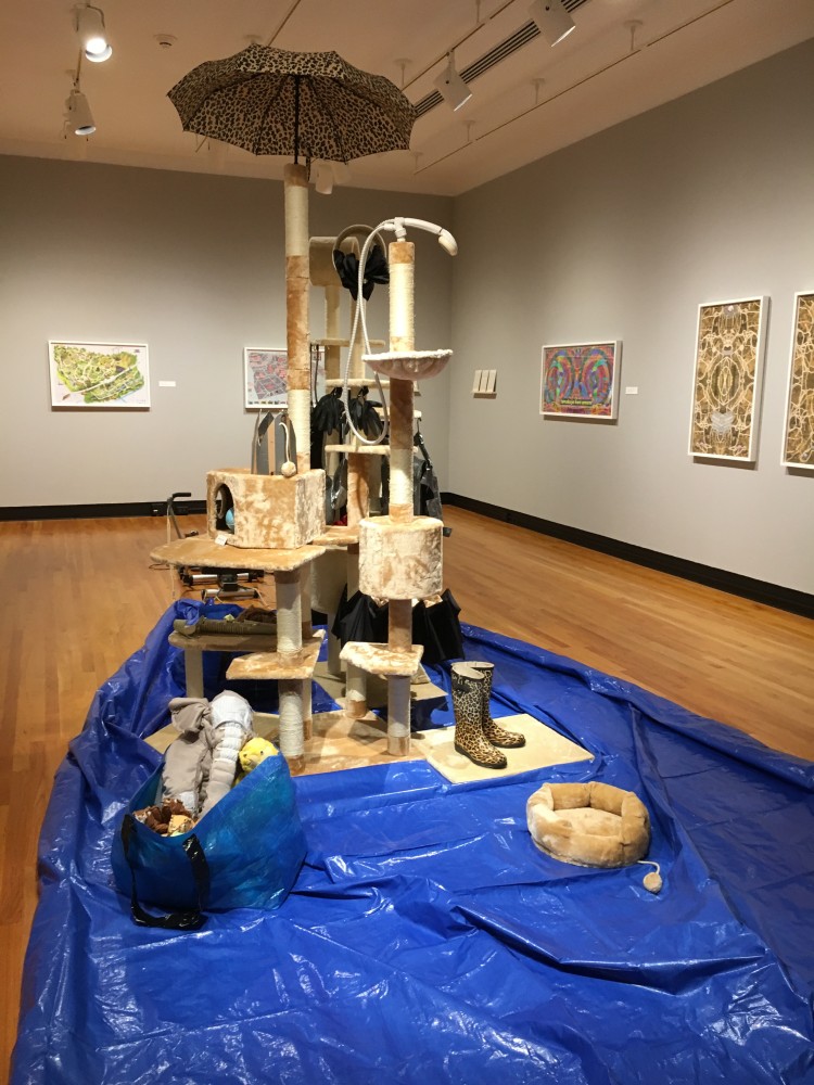 Base Camp, 2017
Blue tarp, shoes, trousers, jacket, cooking utensils, makeshift shower fabricated from tape and cardboard, boots, umbrella
Dimensions variable