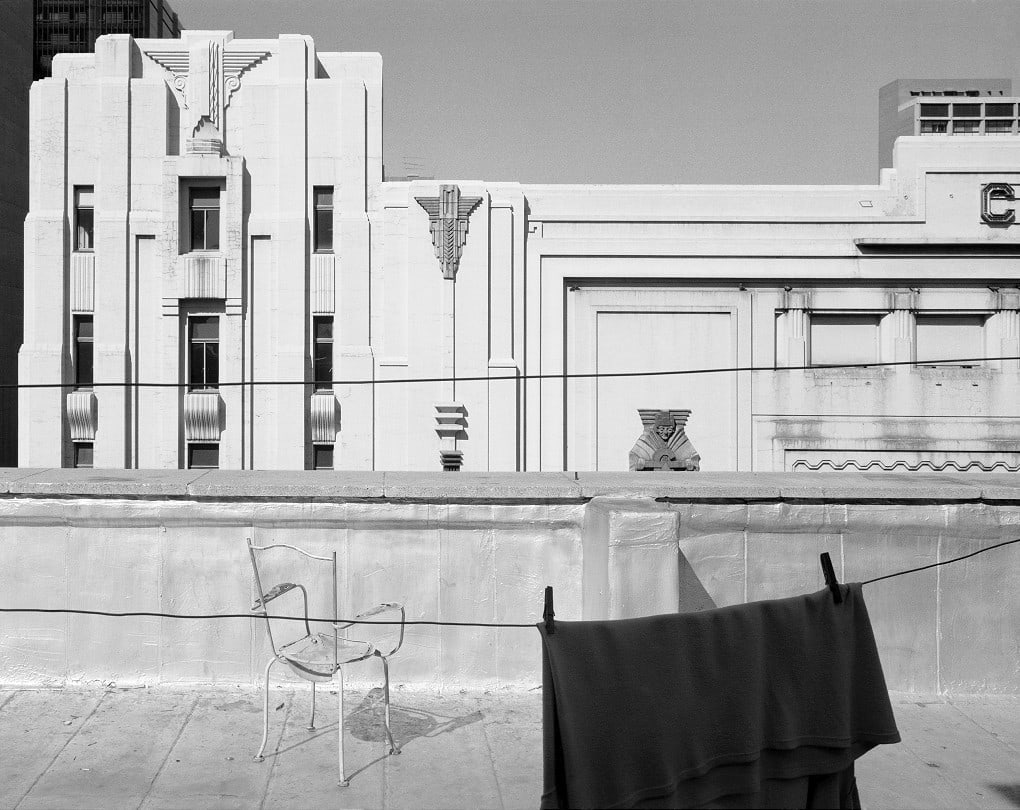 David Goldblatt Location in the sky: Chair and the Colosseum, Johannesburg (4_3542), July 1984 Silver gelatin hand print Image: 28 x 35 cm (11 x 13.8 in.) Unique