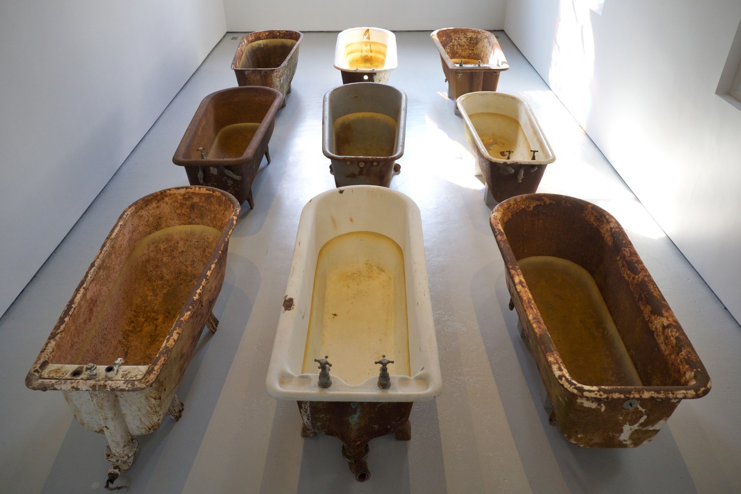 Dorothy Cross
Eye of Shark,&amp;nbsp;2014
9 cast iron baths, marble panel, shark eye and display box, amber glass, dimensions variable
Installation at Lismore Castle Arts, Waterford