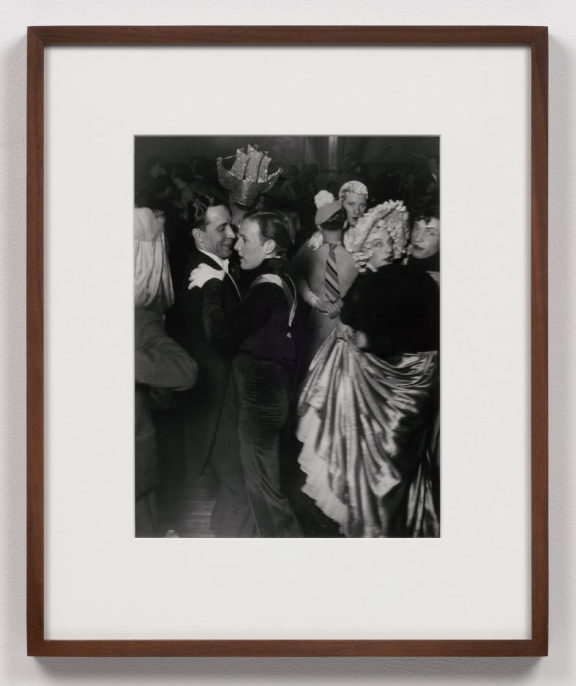 A black and white photographic print by Brassai depicting couples dancing at the Magic-City Ball