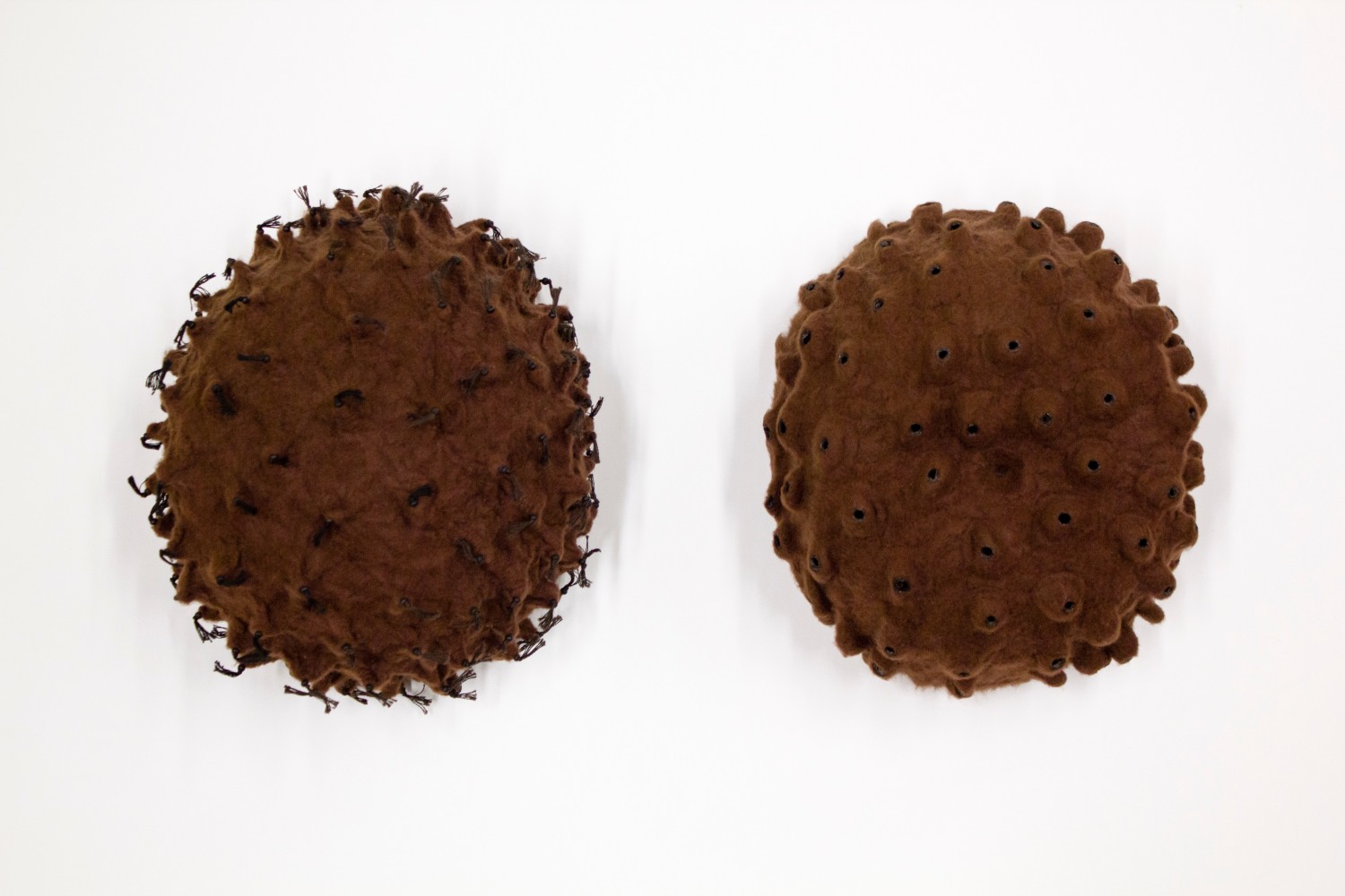 Sonya Clark&amp;nbsp;
Skin Pair, 2001
Polyester, felt, thread, wood mount
(left) Object #23: 9 3/4 x 8 x 5 in. (24.77 x 20.32 x 12.7 cm)
(right) Object #24: 9 x 8 x 4 in. (22.86 x 20.32 x 10.16 cm)
Clar-1035-C