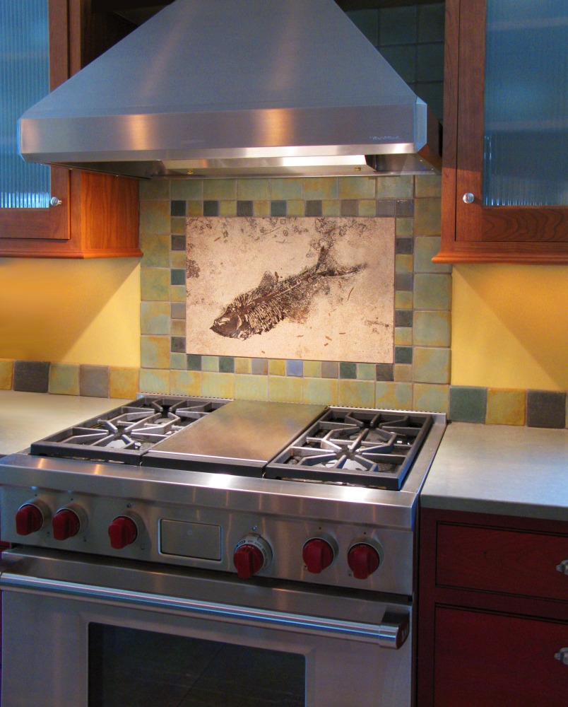 A 16&quot; x 24&quot; honed fossil tile is the centerpiece in a ceramic tile backsplash