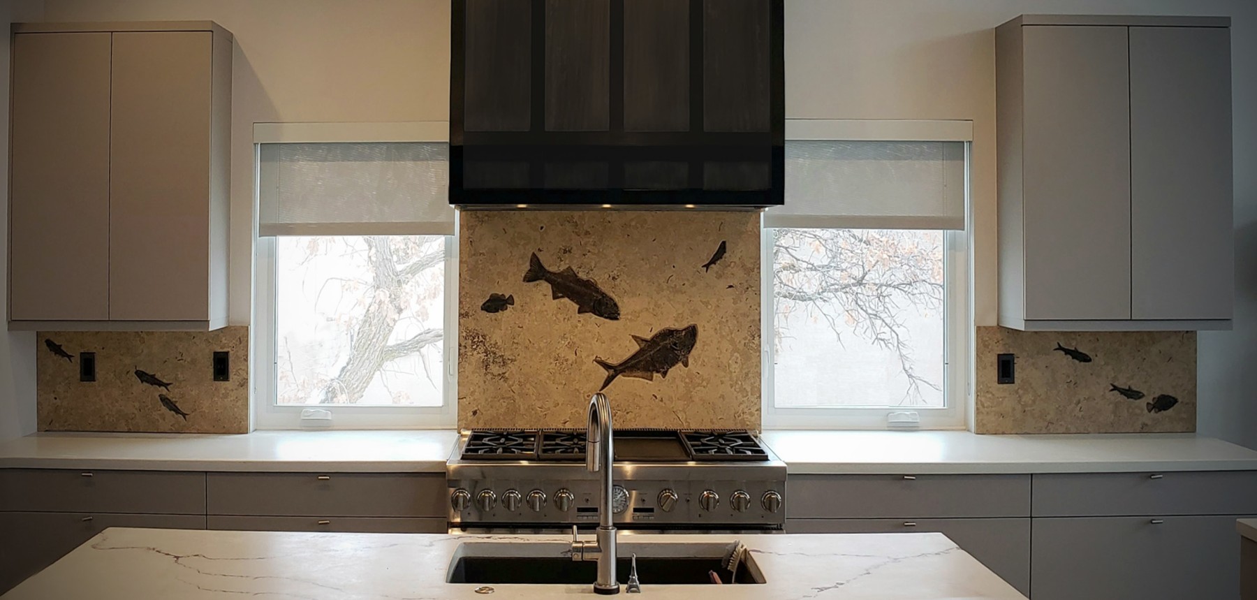 Fossil tile backsplash in three sections