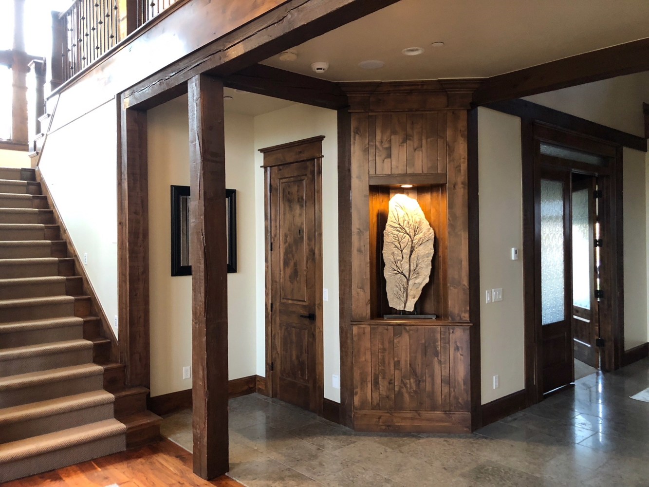 A fossil sculpture containing a rare 50 million year old palm flower rests in a lighted alcove