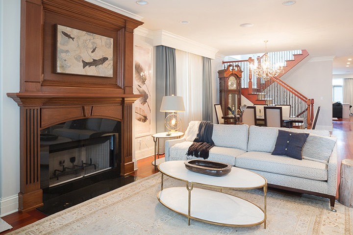 An Accent sized fossil mural hangs above a fireplace in a contemporary living room