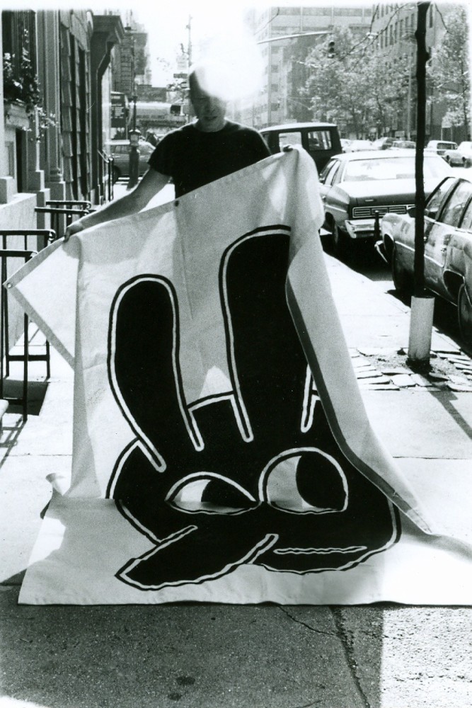 Ray Johnson with a bunny banner to be placed on display in his show, &amp;ldquo;More Works by Ray Johnson 1951-1991&amp;rdquo; at Goldie Paley Gallery, Moore College of Art, Philadelphia, 12/1991. Photographer unknown.