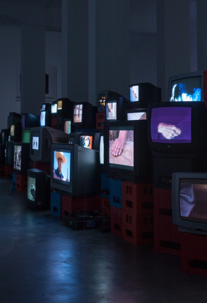 Douglas Gordon Pretty much every film and video work from about 1992 until now. 1999 82 video works on 101 TV monitors, video players, beer crates Installation 200 x 1530 x 620 cm / 78 3/4 x 602 3/8 x 244 1/8 in