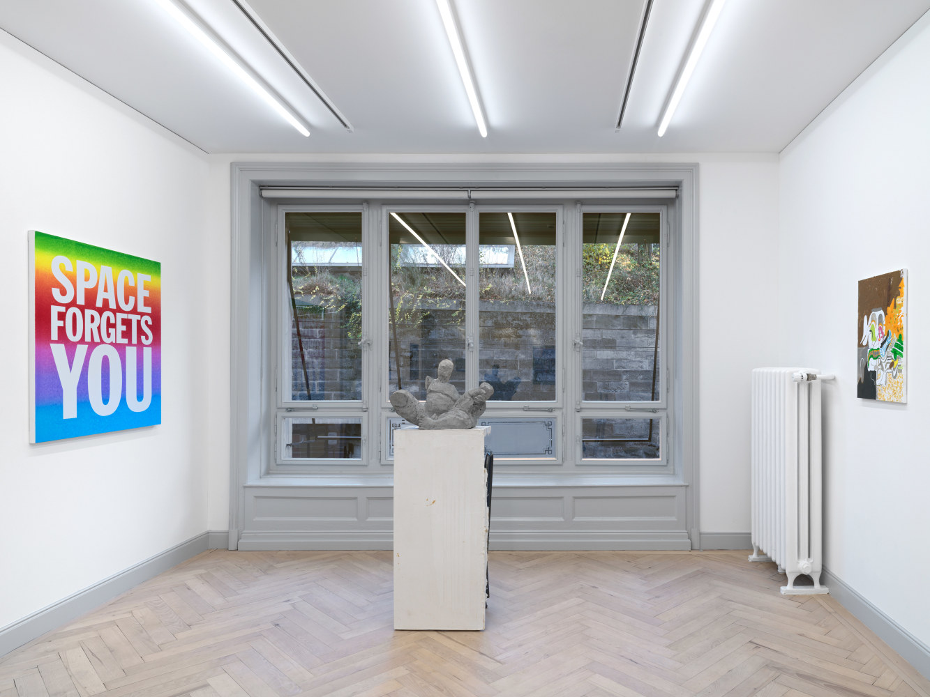 Installation view of group painting, photography, and sculpture exhibition