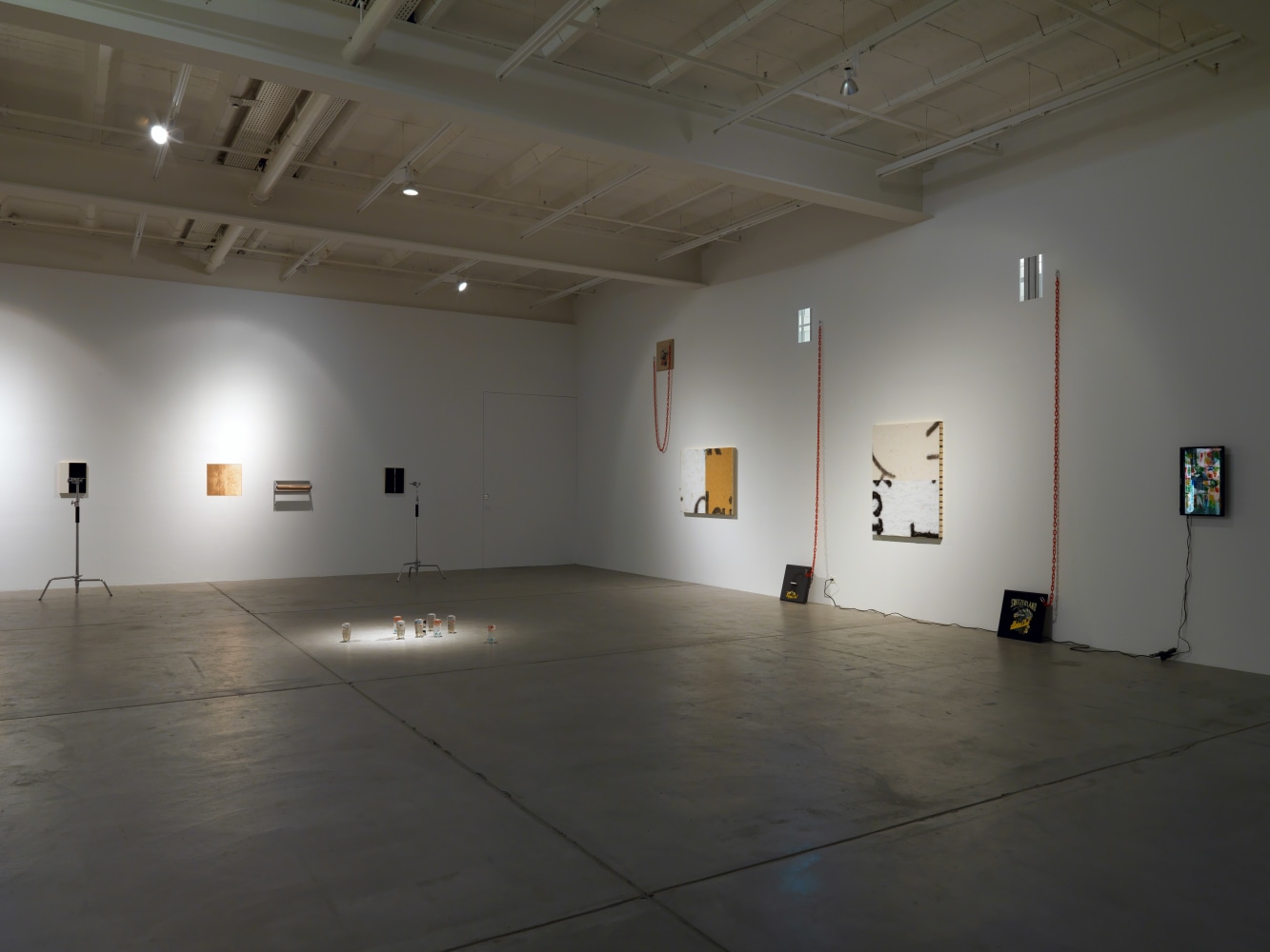 Installation view of Adam Pendleton and Pope.L wall-based works and sculptural installation