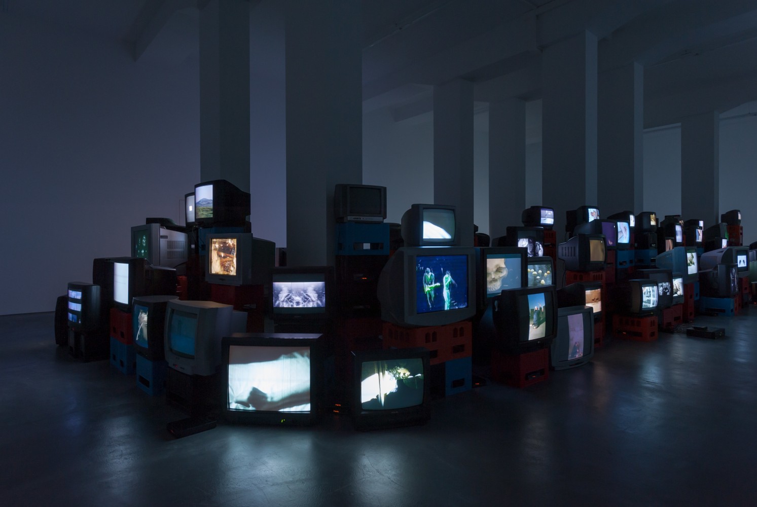 Douglas Gordon Pretty much every film and video work from about 1992 until now. 1999 82 video works on 101 TV monitors, video players, beer crates Installation 200 x 1530 x 620 cm / 78 3/4 x 602 3/8 x 244 1/8 in