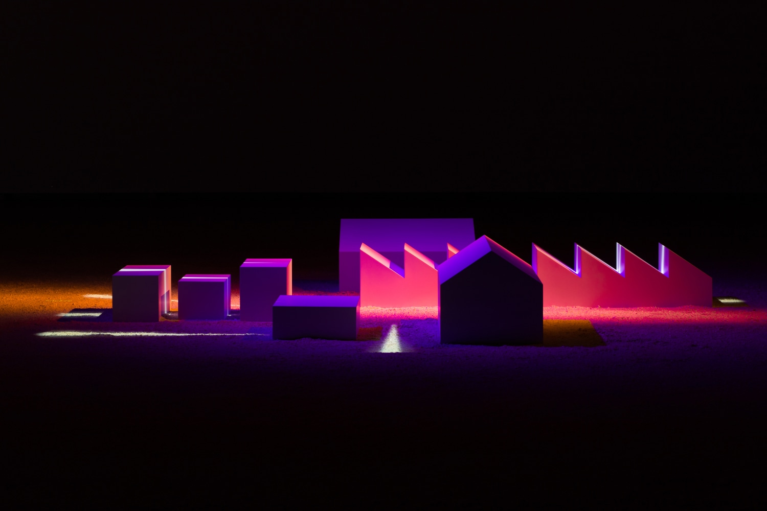 Installation by Liam Gilllick, The Light is no Brighter at the Centre 2017 Painted MDF, theatre lights, HD projection, sawdust 9:21 min Installation dimensions variable