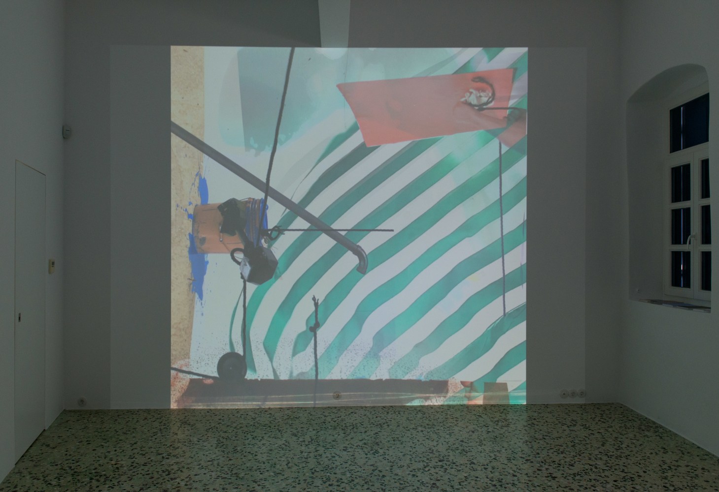 Installation view of projected film and projector by Alex Hubbard