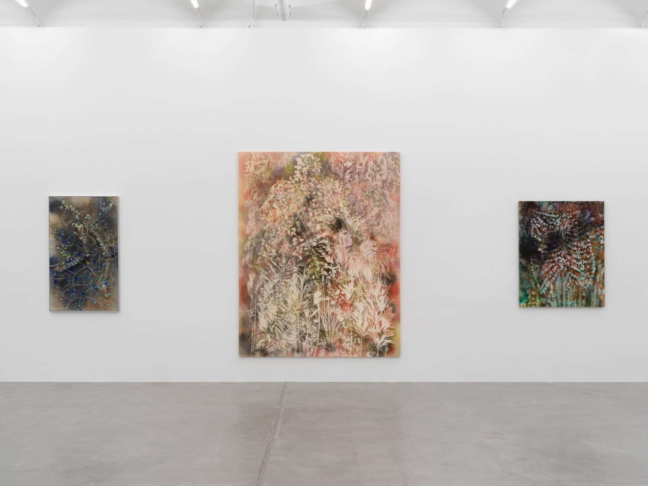 Installation view of Sam Falls paintings and ceramic reliefs exhibition