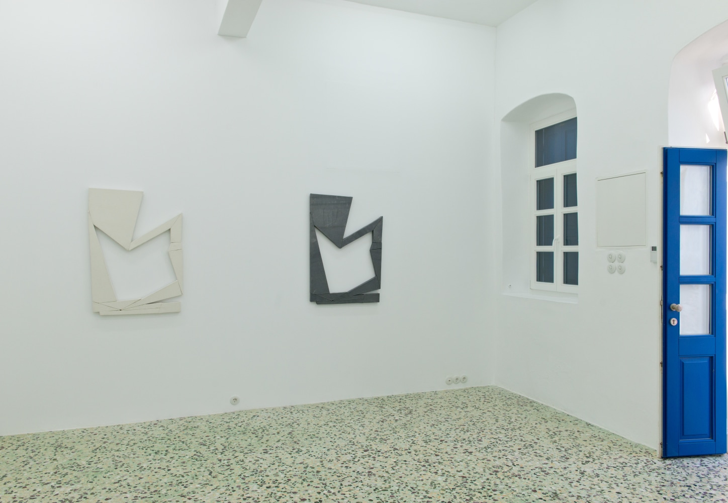 Installation view of Wyatt Kahn wall reliefs, photographs, works on paper