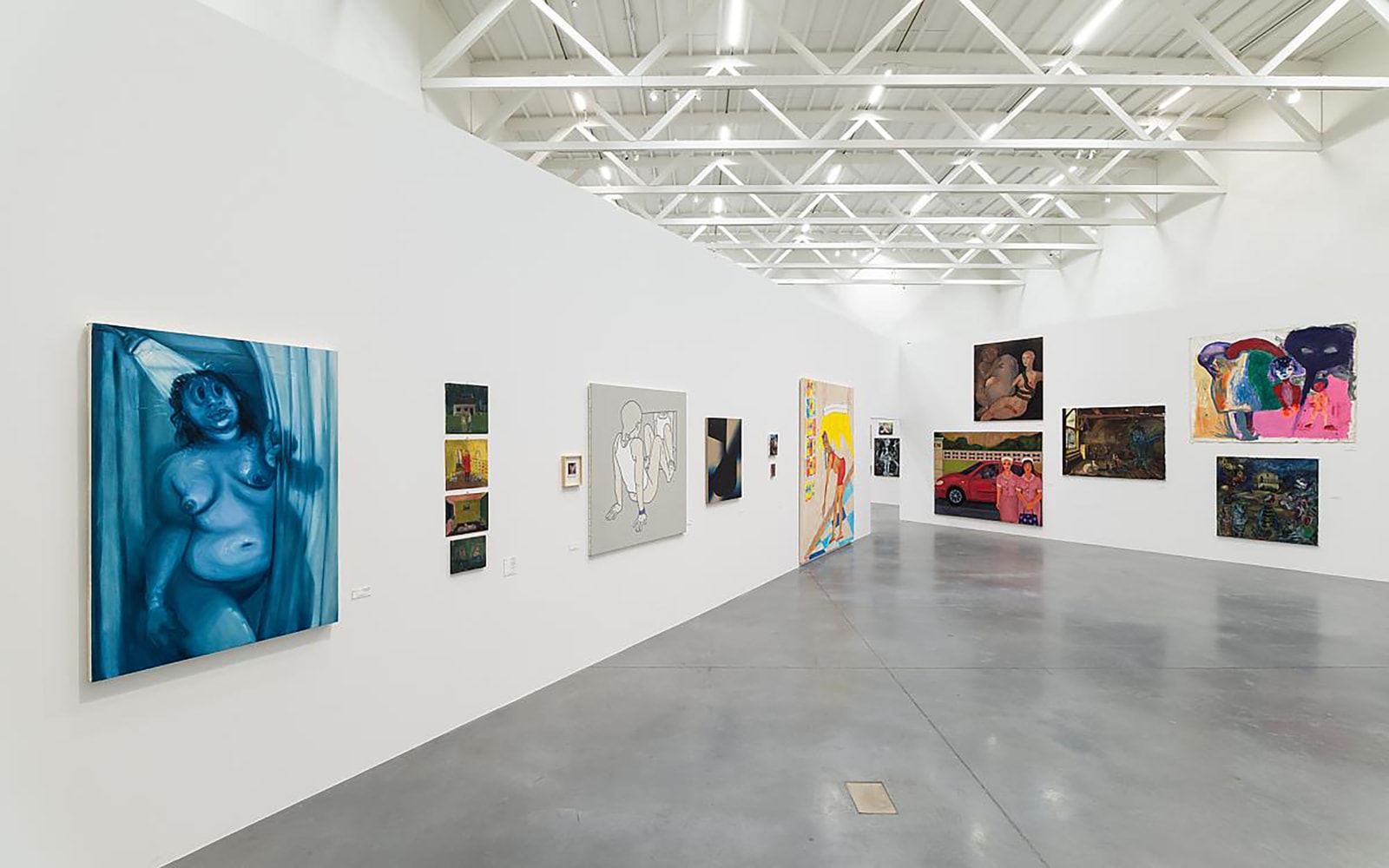 Installation view of painting by Tschabalala Self and paintings of other artists