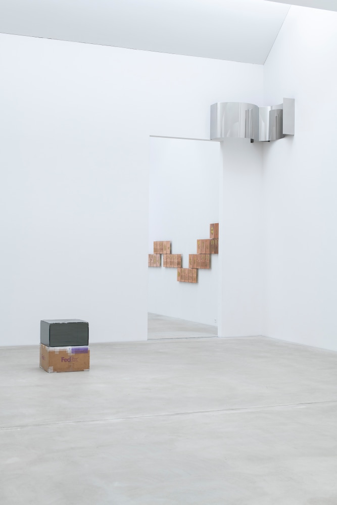 Installation view of a sculpture and wall works by Walead Beshty