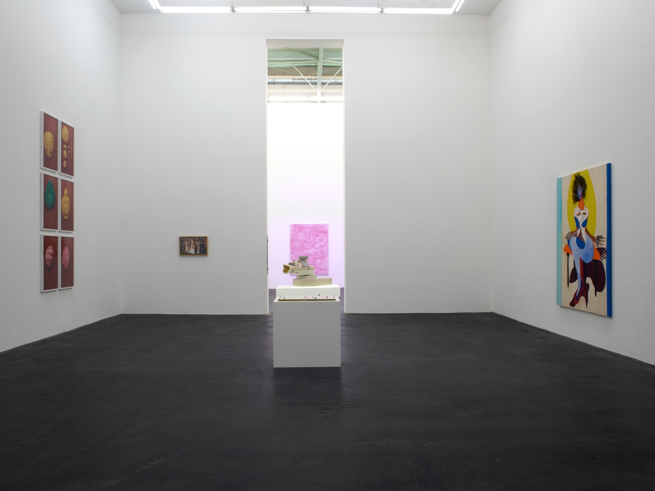 Installation view of painting by Tschabalala Self and paintings of other artists