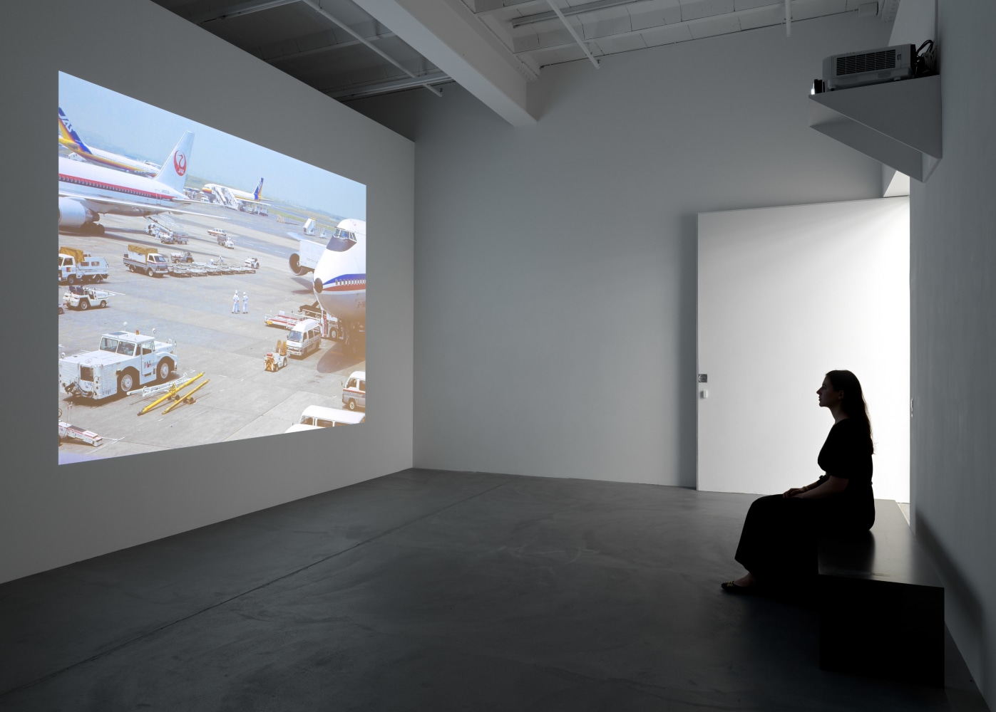 installation view of photographs of airports and car sculptures by Peter Fischli and David Weiss