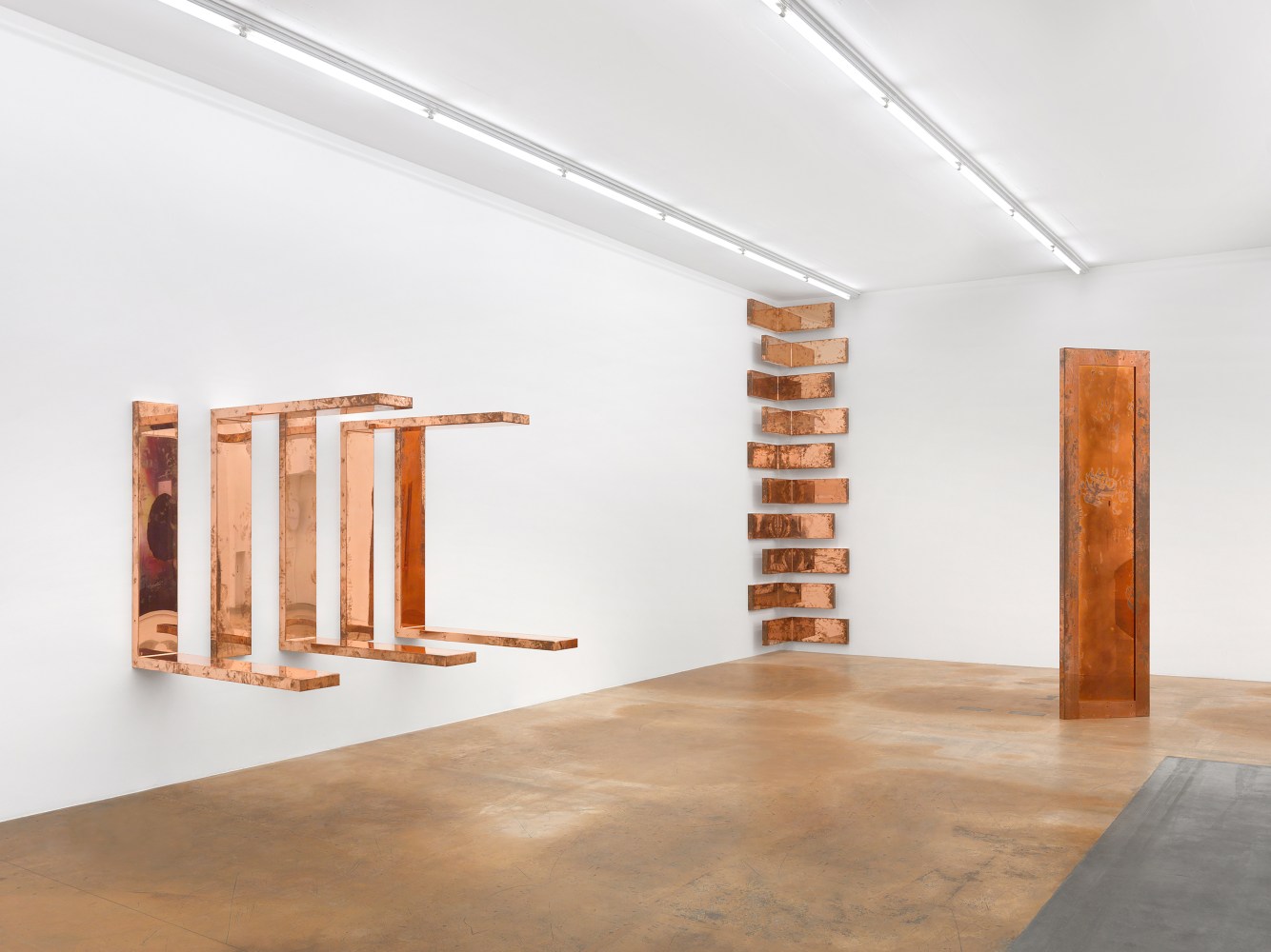 Installation view of sculptures and wall works by Walead Beshty
