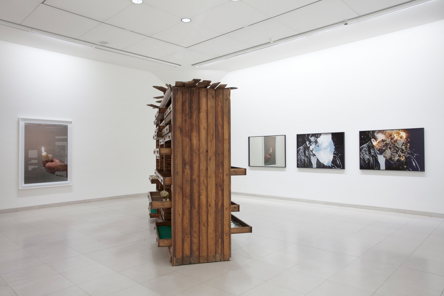 Installation view of photographs and sculptures by Douglas Gordon