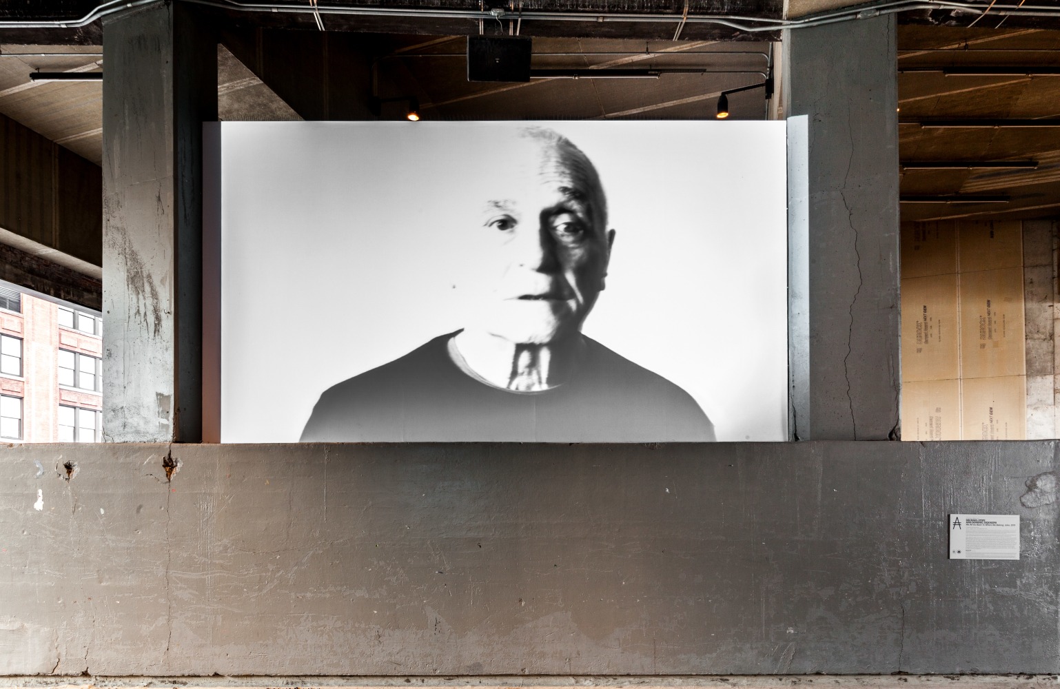 Installation view of video work by John Giorno