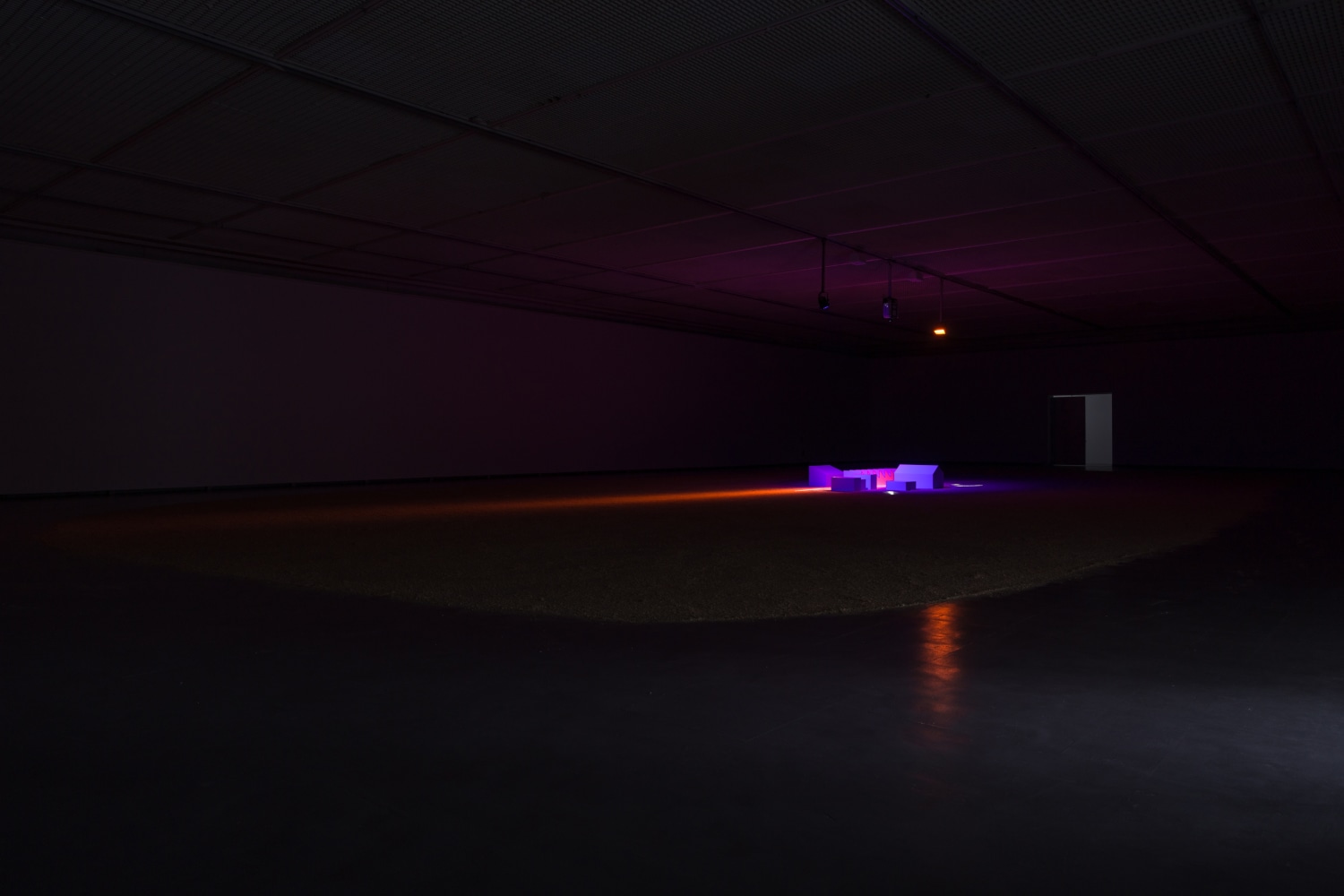 Installation by Liam Gilllick, The Light is no Brighter at the Centre 2017 Painted MDF, theatre lights, HD projection, sawdust 9:21 min Installation dimensions variable
