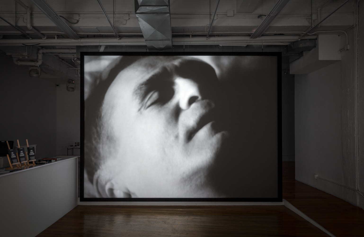 Installation view of video work by John Giorno