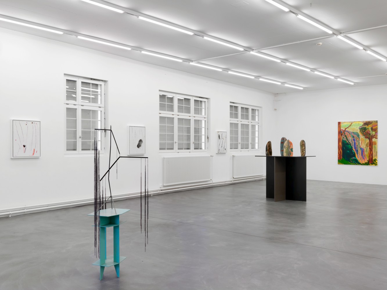 Installation view of group painting, photography, and sculpture exhibition