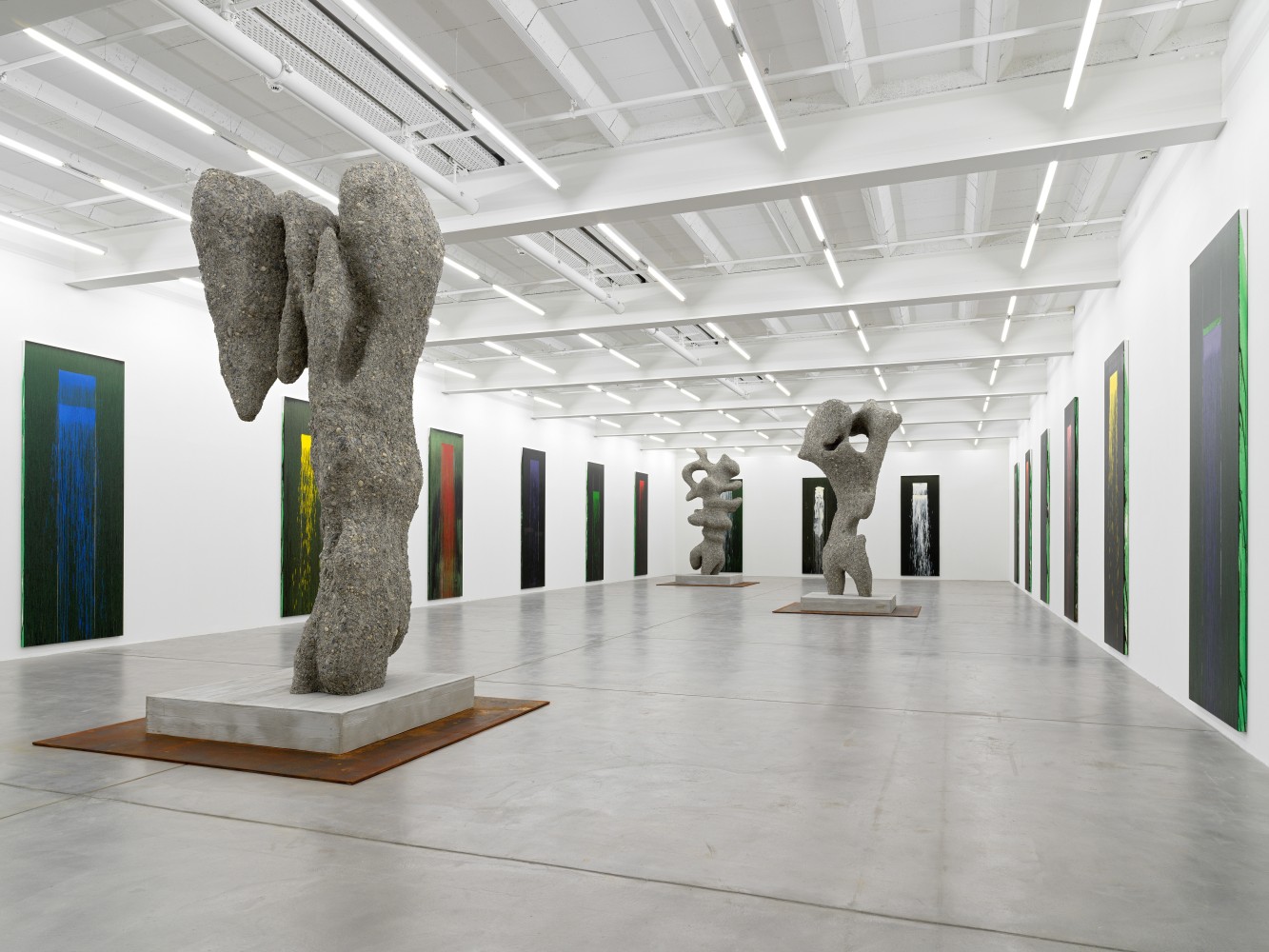 Installation view of paintings by Pat Steir and sculptures by Ugo Rondinone