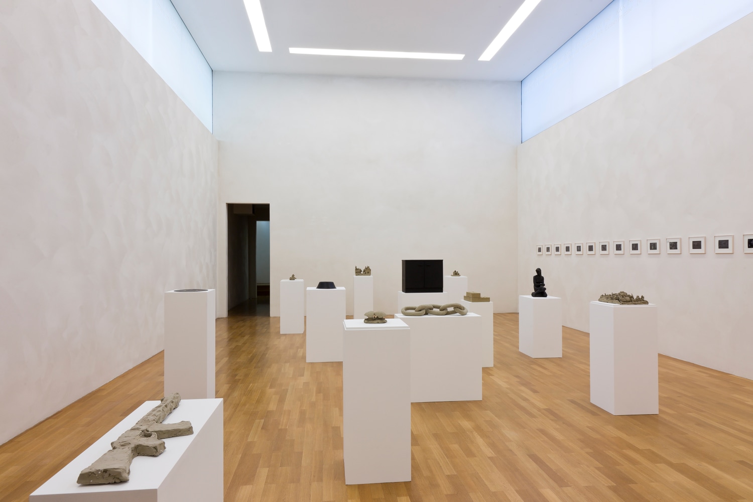 Installation view of sculptures and photographs by Peter Fischli and David Weiss