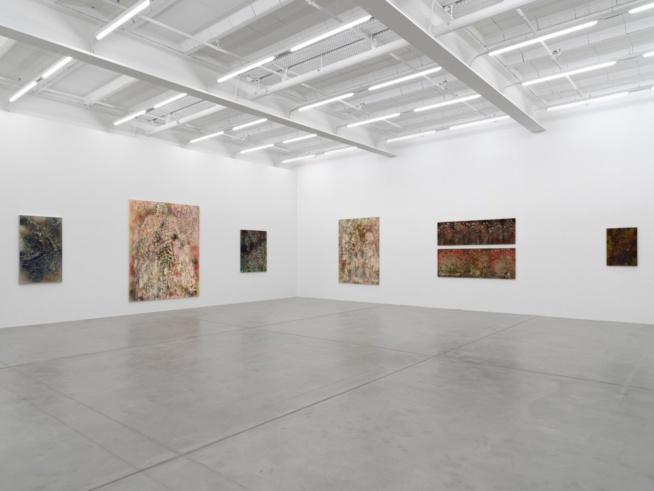 Installation view of Sam Falls paintings and ceramic reliefs exhibition