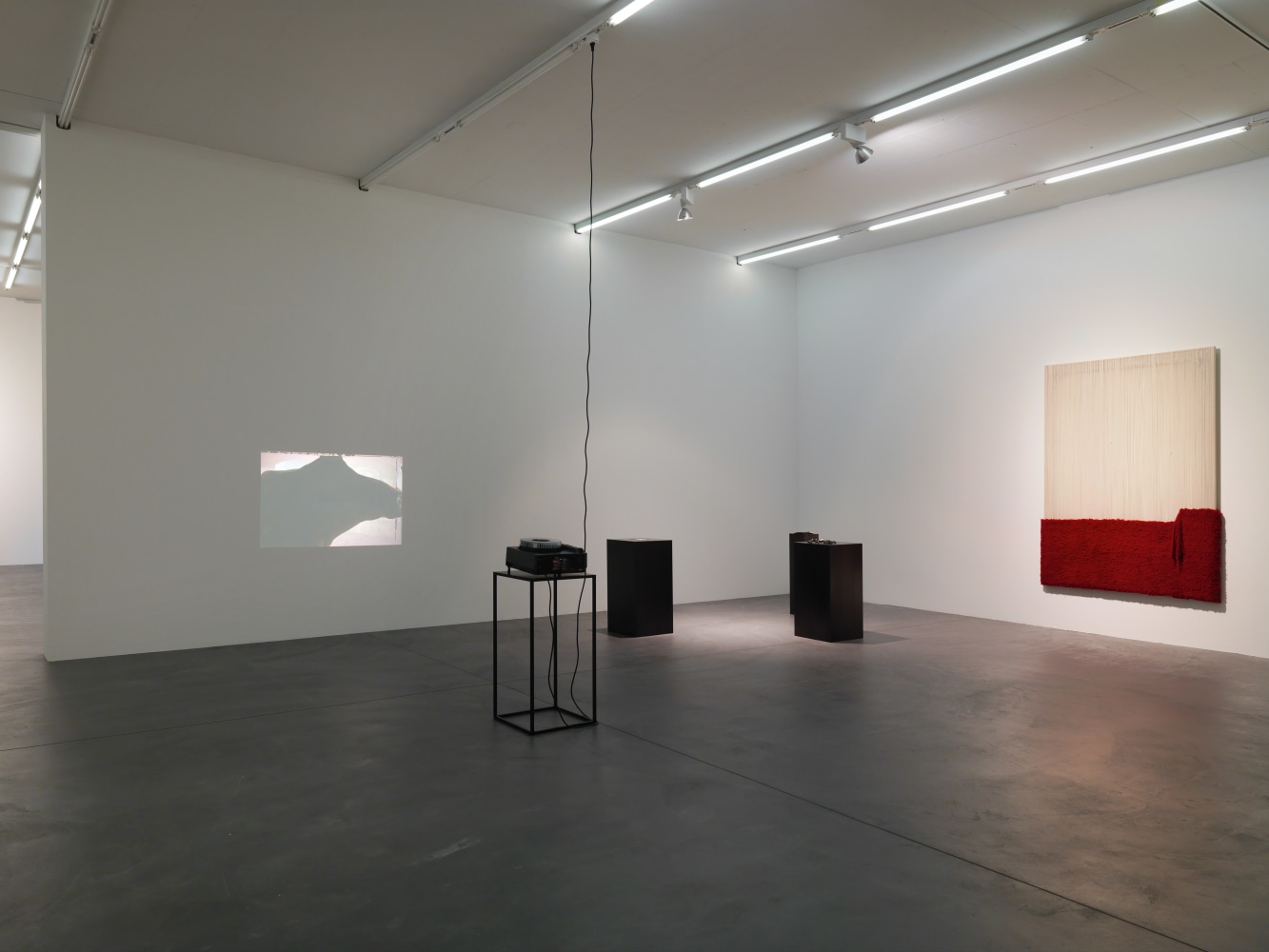Installation view of paintings, video works and wall works by Latifa Echakhch