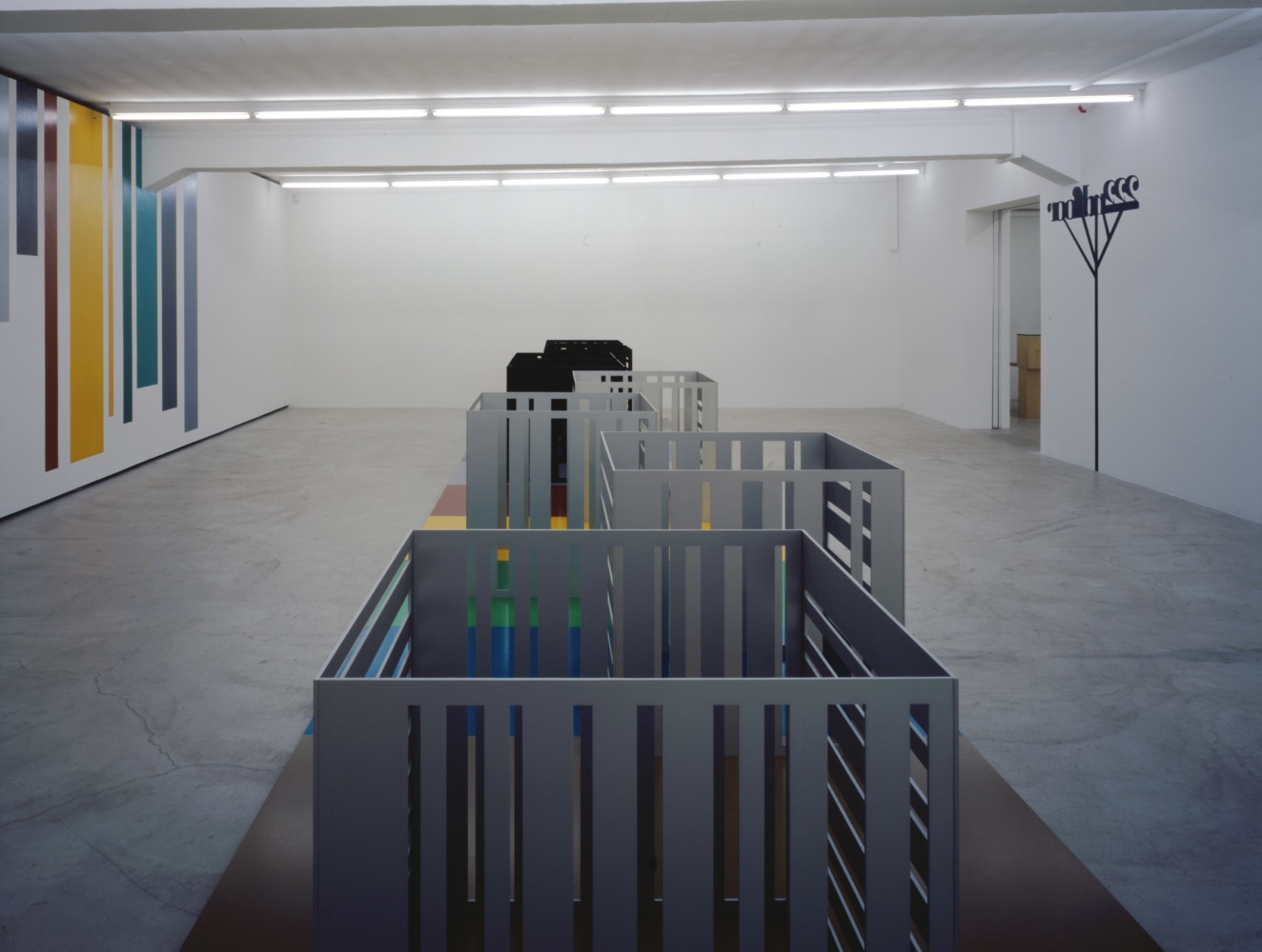 Installation view of Liam Gillick wall-based graphic work and sculpture exhibition