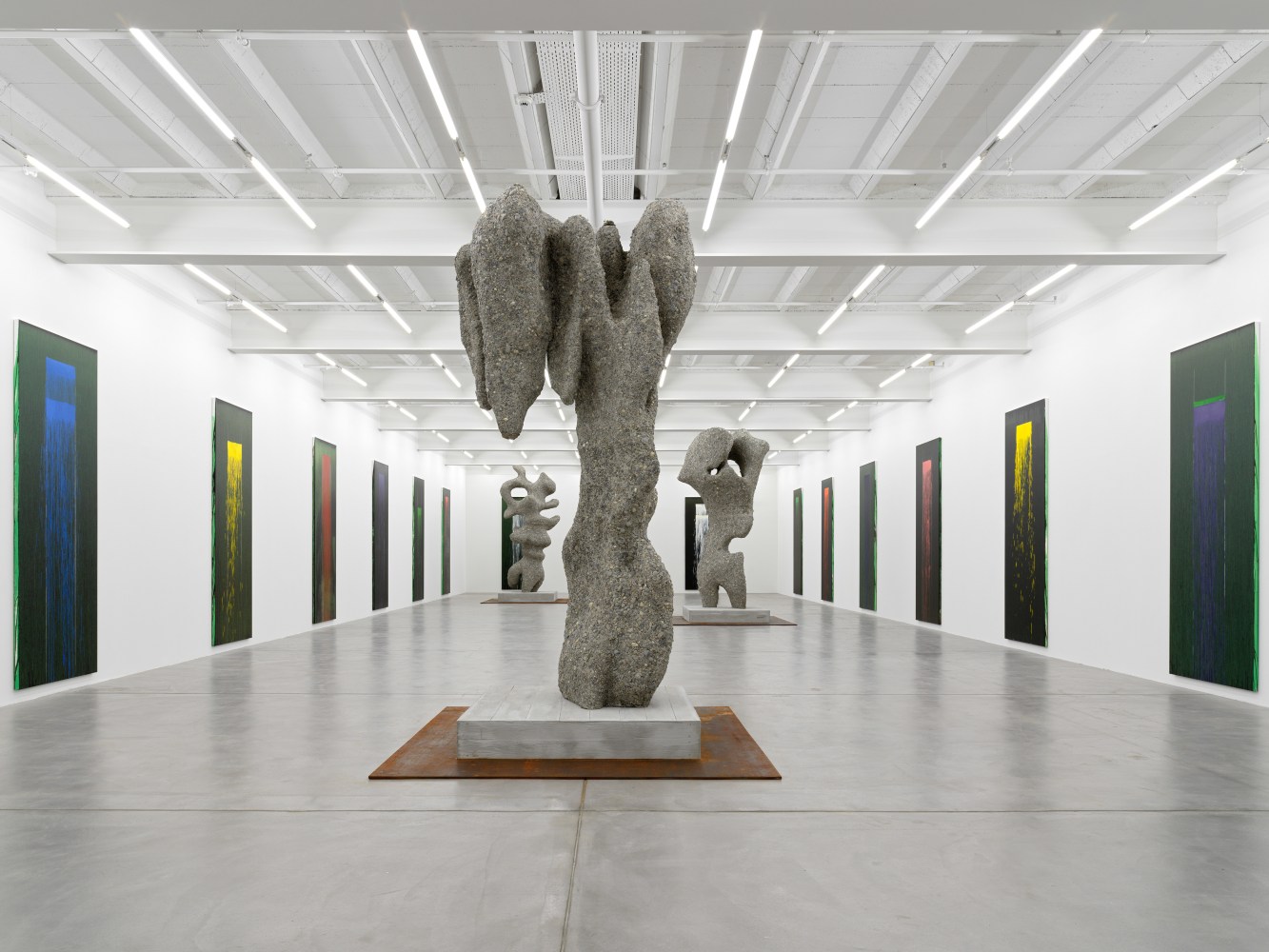 Installation view of paintings by Pat Steir and sculptures by Ugo Rondinone