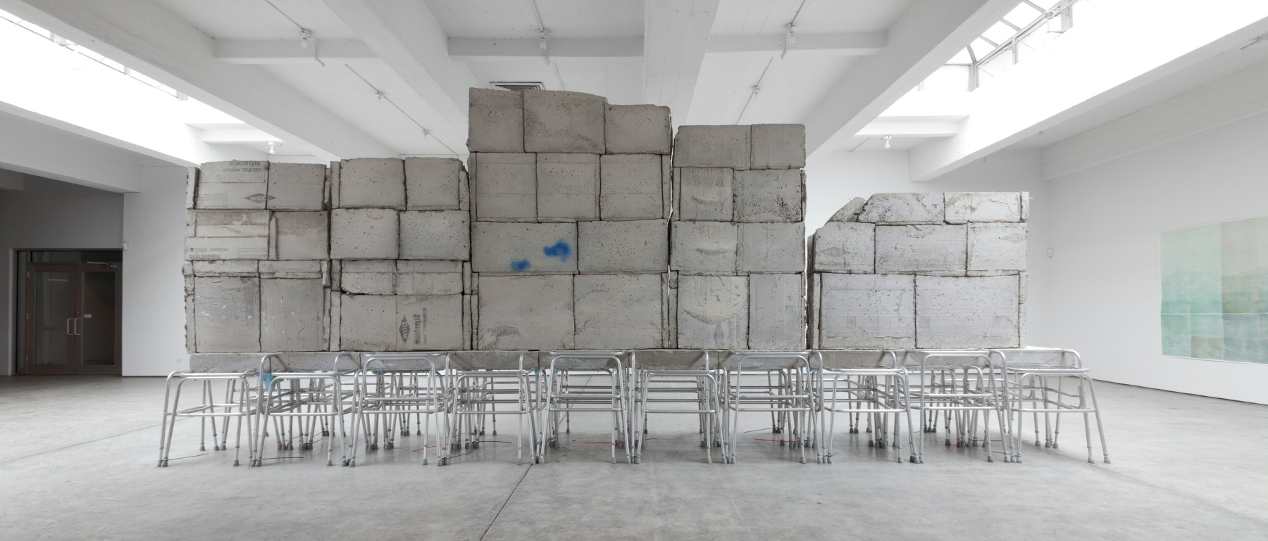 Indoor view of Justin Matherly sculpture, Handbook of inner culture for external barbarians (we nah beg no friend) 2013 Concrete, ambulatory equipment, spray paint 307 x 749 x 114 cm / 121 x 295 x 45 in