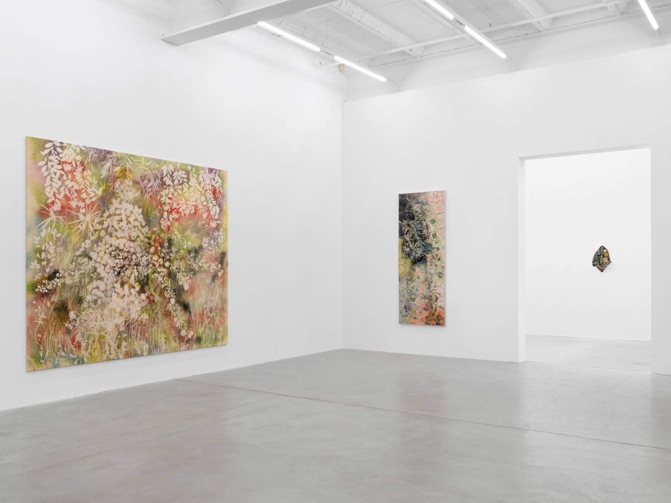 Installation view of Sam Falls paintings and ceramic reliefs exhibition