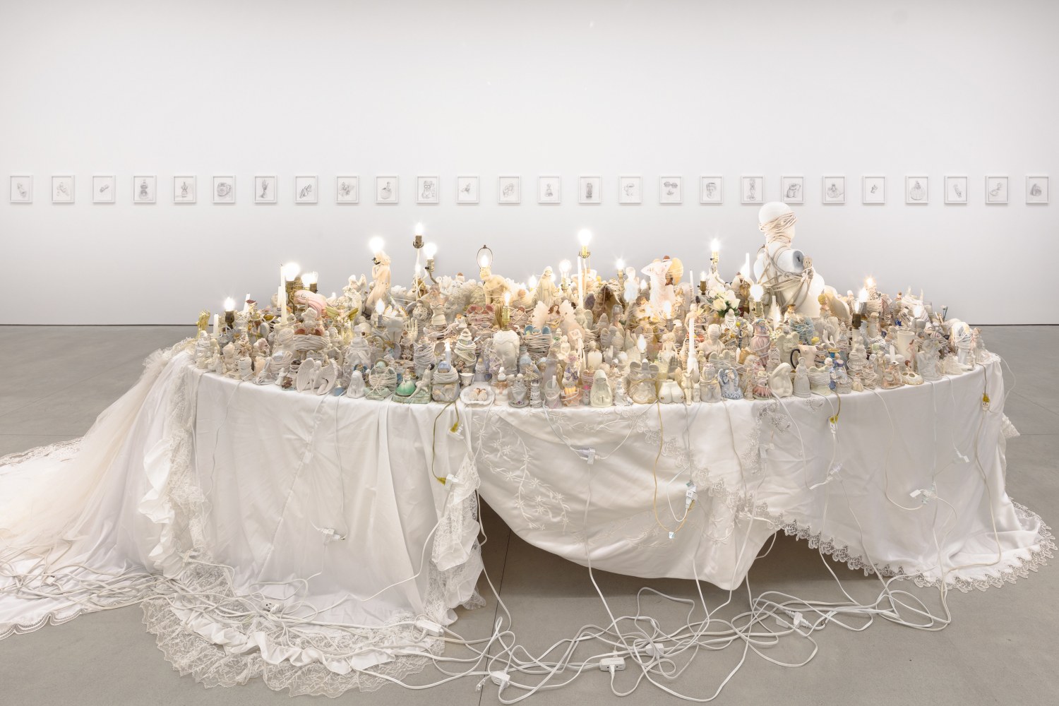 Portia Munson
Bound Angel, 2021
found figurines, lamps, candles, string &amp;amp; rope, wedding gowns as tablecloth, extension cords, oval table
192 x 68 x 66 ins.
487.7 x 172.7 x 167.6 cm