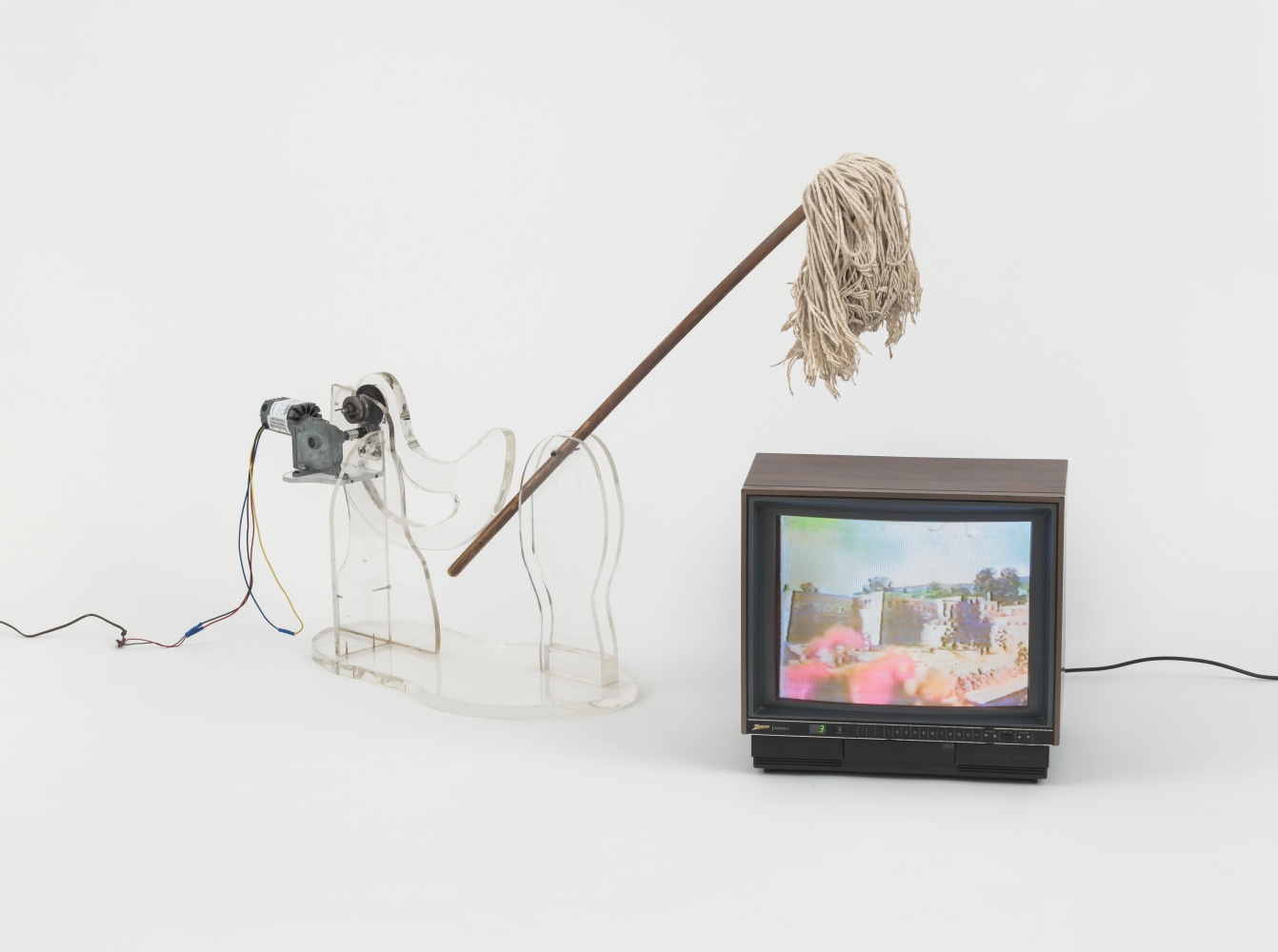 Carolee Schneemann
War Mop, 1983
plexiglass construction, mop, motor, video monitor
Sculpture: 24 x 62 x 20 inches; TV: 12 x 18 x 10 inches