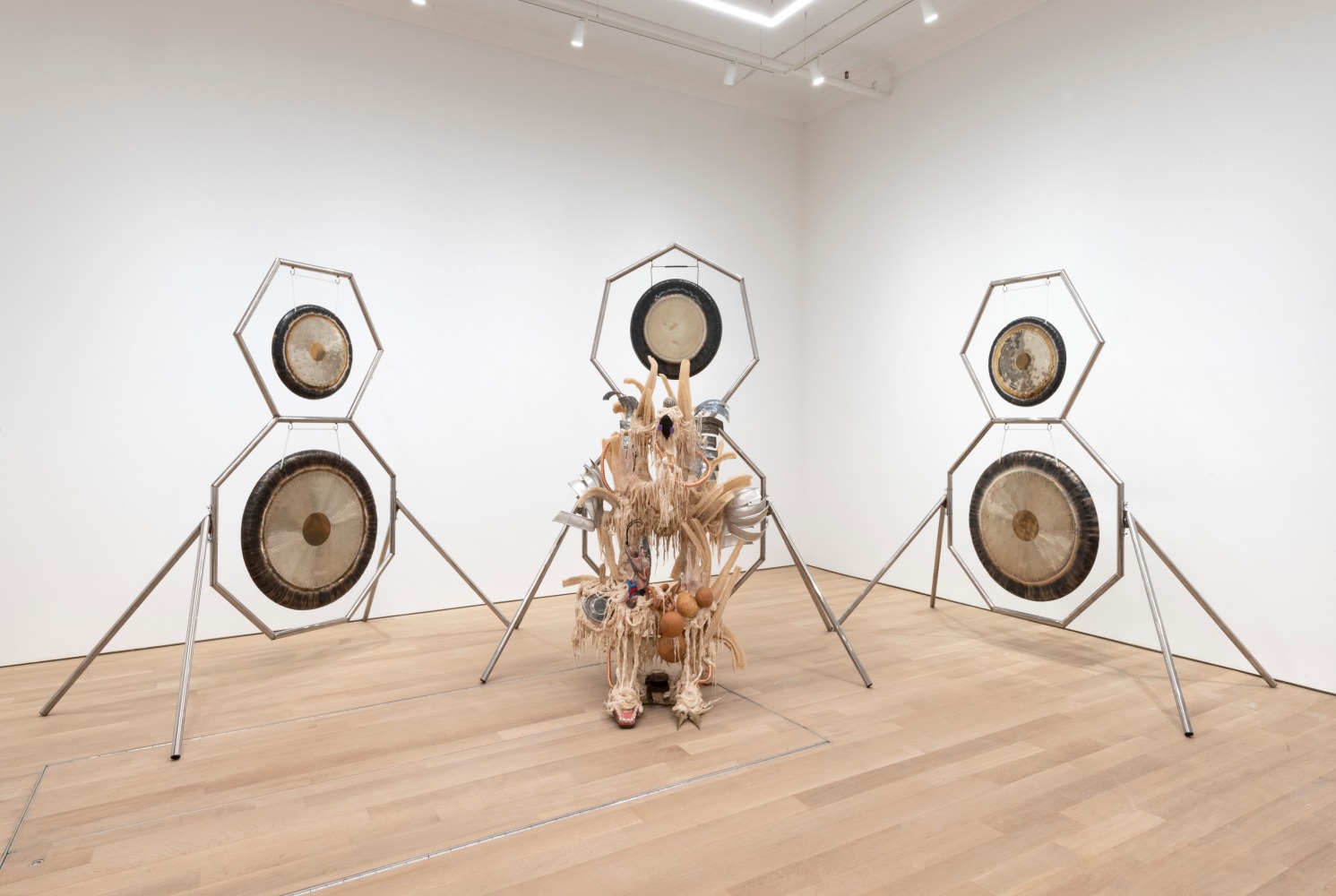 Guadalupe Maravilla
Disease Thrower #17, 2021
gong, steel, wood, cotton, glue mixture, plastic, loofah, and objects collected from a ritual of retracing the artist&amp;#39;s original migration route
99 x 96 x 55 ins.
251.5 x 154.9 x 139.7 cm