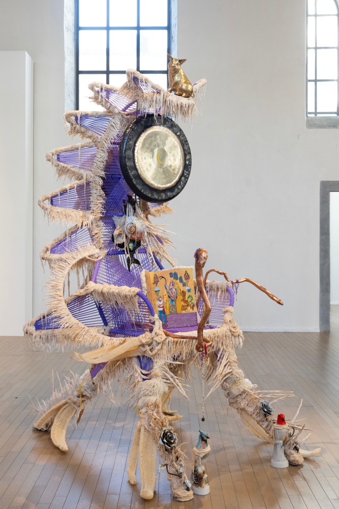 Guadalupe Maravilla
El Brujo Disease Thrower, 2024
steel gong, cotton, glue mixture, plastic, loofah, oil on tin, and objects collected from a ritual of retracing the artist&amp;#39;s original migration route
100 x 80 x 60 ins.
254 x 203.2 x 152.4 cm
(MARAVILLA-200)