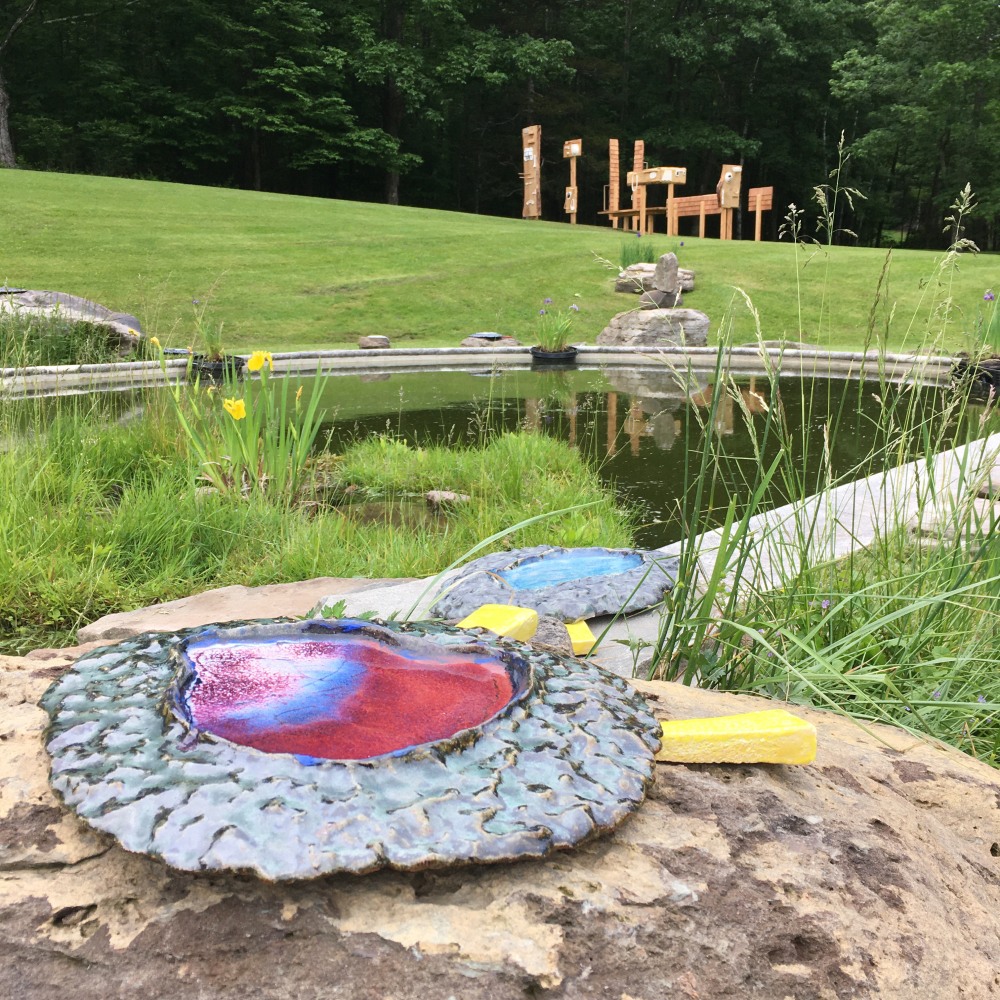 Color photograph of an outdoor ceramic sculptural installation by Pam Lins at the Al Held Foundation, 2021. Exhibition curated by Alyson Baker and River Valley Arts Collective